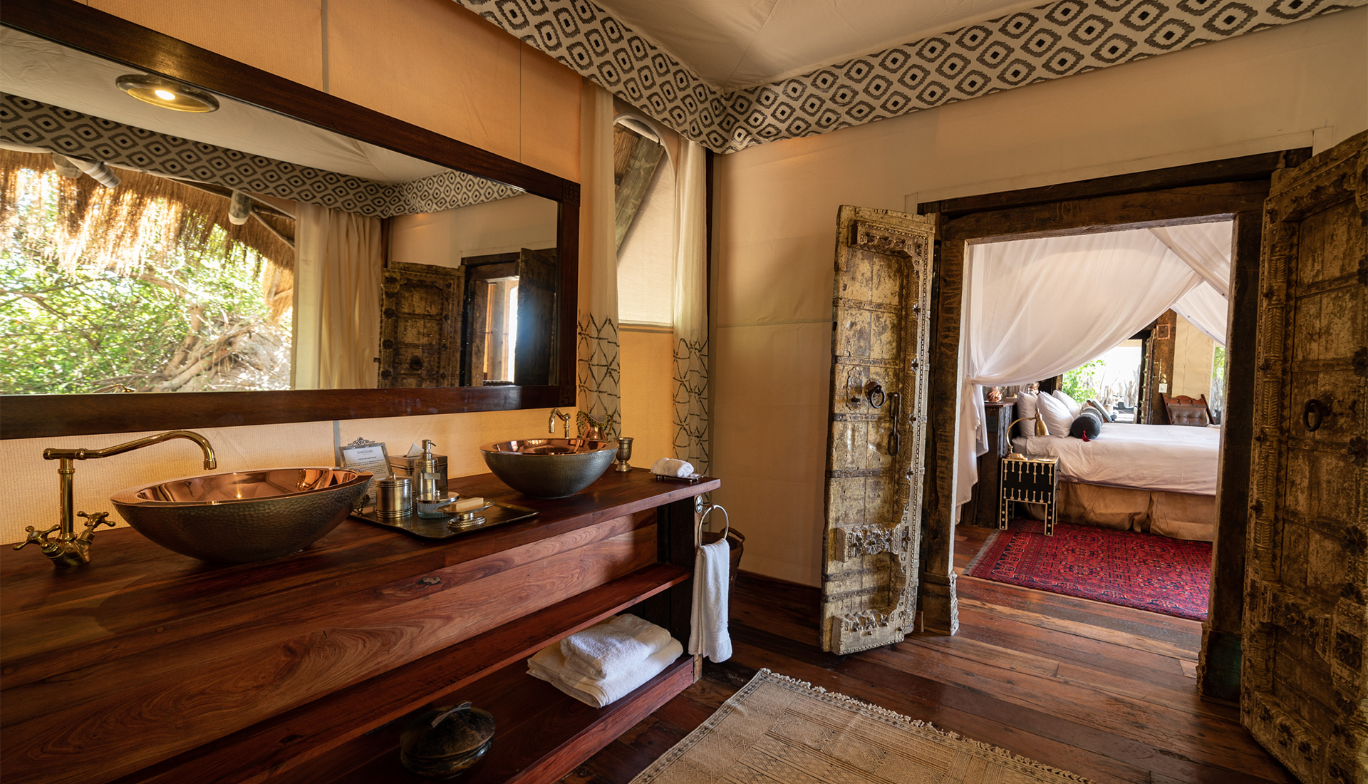 Guest bathroom and bedroom doorway at Selinda Camp