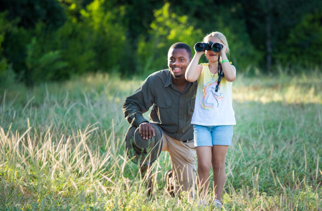 Great Plains Young Explorer Safari looking through binoculars Great Plains Young Explorer Safari looking through binoculars