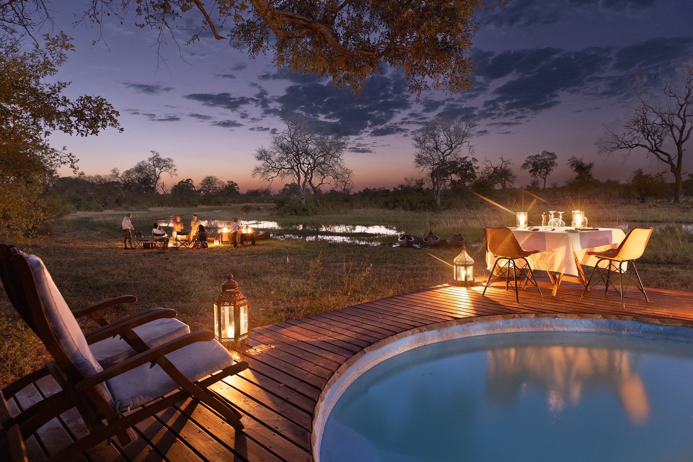 Pool and candlelit dining at night at Selinda Explorers Camp